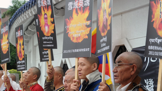 Tibetans at a protest in Taipei, Thailand, in 2011 with portraits of people who committed self-immolation.